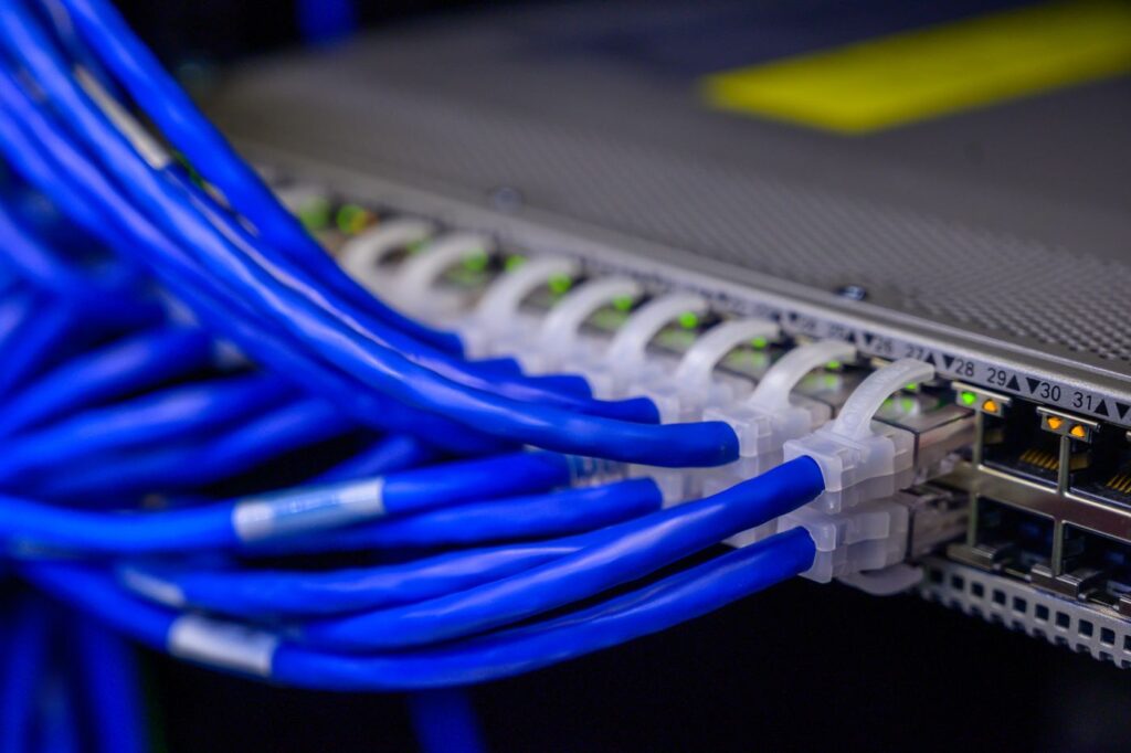 Blue network cables patched into a switch