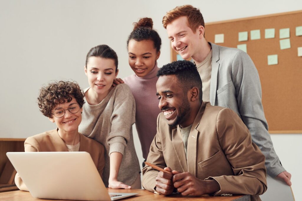 Colleagues reviewing something together on a laptop screen