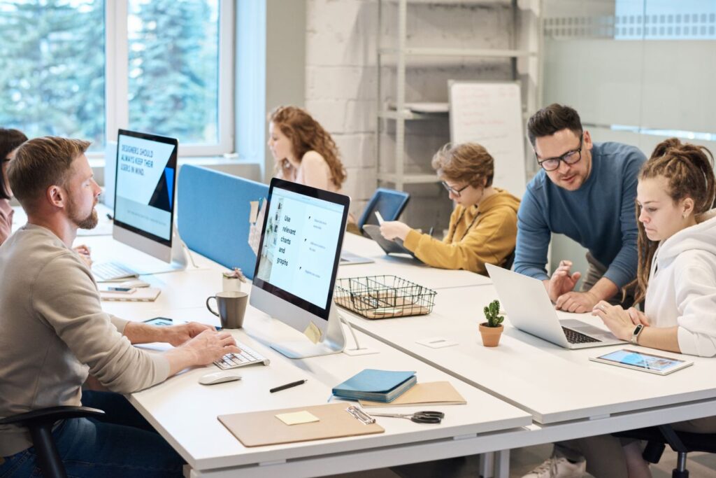 Team working together at computers in a small business office