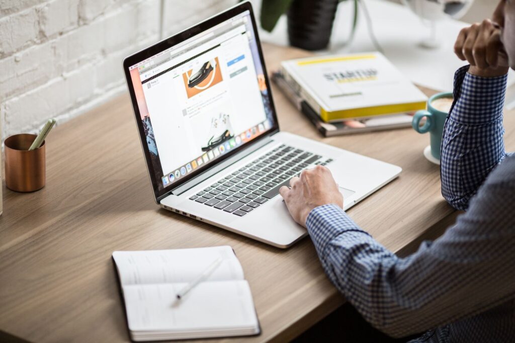 Person working on a laptop at a tidy office desk