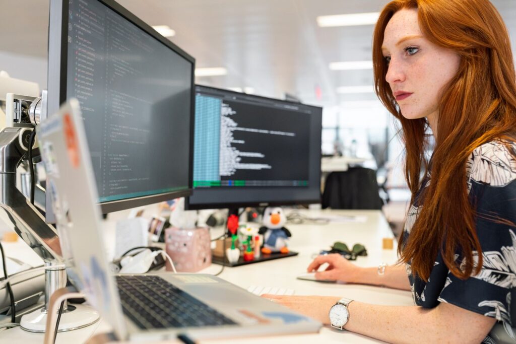 IT professional working at a multi-monitor workstation